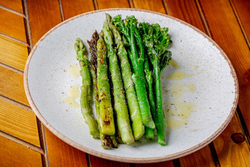 Grilled Homemade asparagus topped with extra virgin olive oil - Image