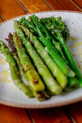 Grilled Homemade asparagus topped with extra virgin olive oil - Image