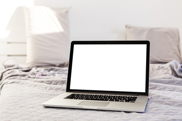 Fototapeta premium The laptop and computer in the morning on a white pillow bed. Lifestyle Concept