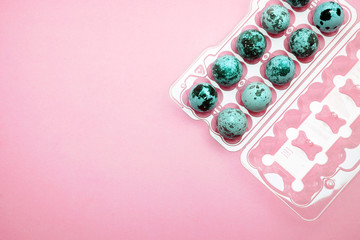 Quail eggs in a plastic egg carton on
