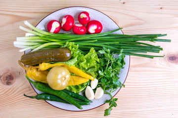 radish, parsley, onion, pickled cucumber and other vegetables on a plate