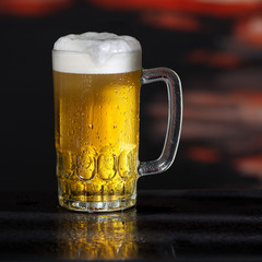 Glass of beer on the dark background