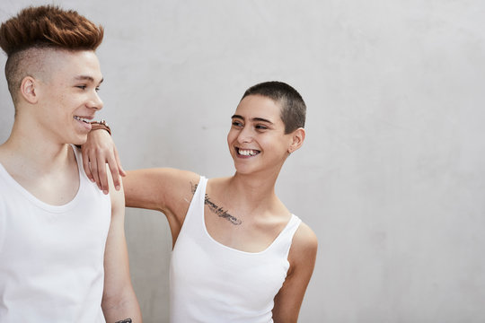 Portrait of smiling young couple wearing vests