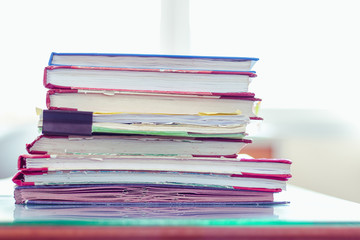 Stack of documents placed on a business desk in a business office.