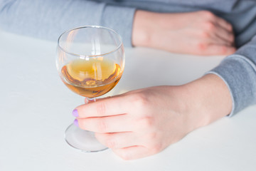girl holding a glass with alcohol on a white background