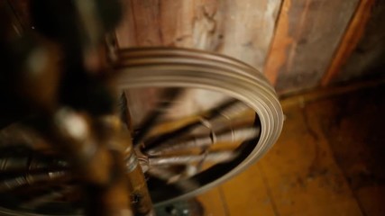 vintage wooden spinning wheel for yarn on a rustic boardwalk background
