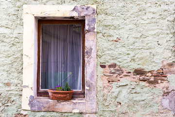 vintage brick wall background with old windowold window with flowers on a stone wall