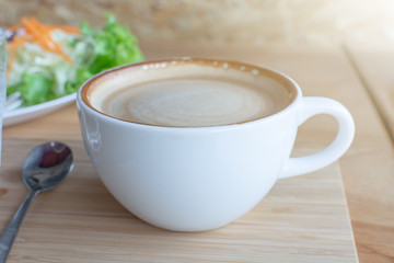 Coffee on wooden table in the morning