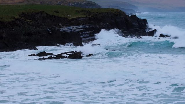 footage of skellig michael in the ring of kerry off the coast of ireland on the wild atlantic way showing crashing waves on black rock and beach
