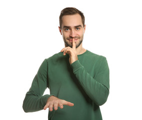 Man showing HUSH gesture in sign language on white background