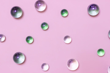 Glass balls on a pink background. Top view.