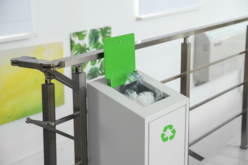 Metal bin with garbage indoors. Waste recycling