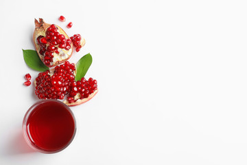 Glass of pomegranate juice and fresh fruits on white background, top view