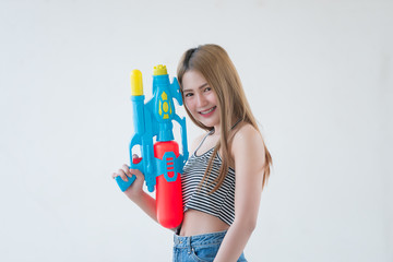 Asian sexy woman with gun water in hand on white background,Festival songkran day at thailand,The best of festival of thai,Land of  smile