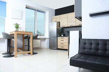 Cozy modern kitchen interior with new furniture and appliances