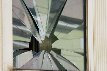 square window with broken glass by stone like star closeup