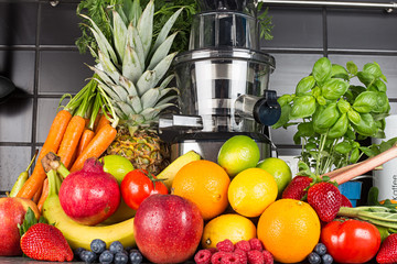 slow juicer in kitchen with many fruit and vegetable juice healthy lifestyle concept background