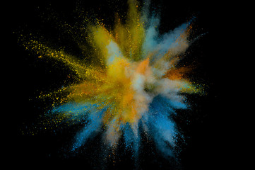 Colored powder explosion. Abstract closeup dust on backdrop. Colorful explode. Paint holi
