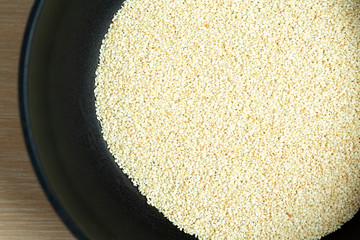 Toasted sesame seeds in a frying pan