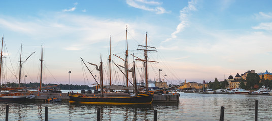 Old Town pier with old boats and sailing ship. Katajanokka district is a famous tourist destination in Helsinki, Finland.