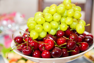 Beautiful fresh fruits and berries in a vase on the table