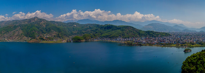 Naklejka premium A panoramic view of Pokhara in Nepal with mountain range behind the clouds