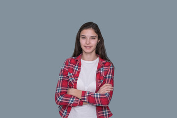 young teen girl, portrait of a smiling cheerful female student, gray background