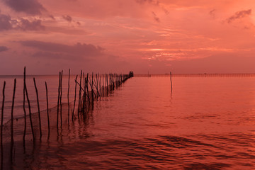 Fototapeta na wymiar Seaweed farms at the west side of Belitung Island during red sunset, Indonesia
