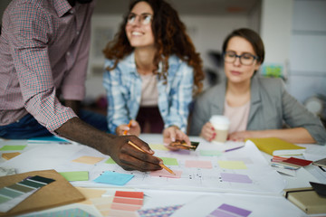Fototapeta premium Portrait of creative business team planning project drawing roadmap in office, focus on foreground, copy space
