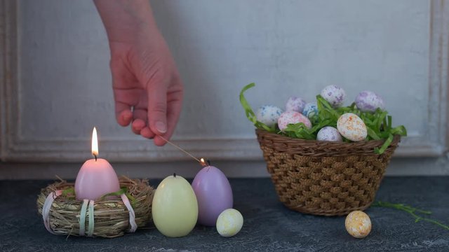 Painted ester eggs in a basket. White vintage wall in background. Copy space.
