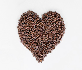 Coffee beans heart isolated on white table close