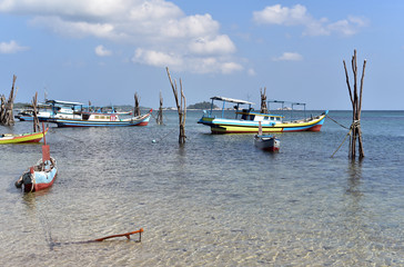 Fishing boats docked at Tanjung Kelayang Beach in Belitung Island, Indonesia