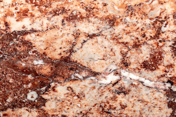 close up of a polished red marbled granite texture