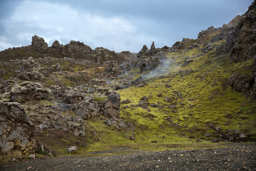 Sharp stony peaks on the green slopes of the Landmannalaugar mountains