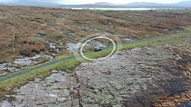 Aerial of self driving car communicationg and tracking it's way in the countryside