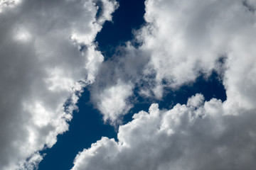 blue sky between sunlit clouds
