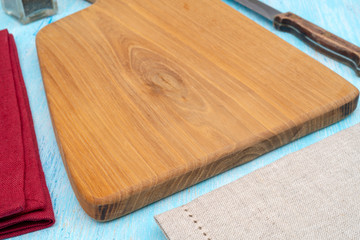 Wooden oak cutting board. Kitchenware. Copy space.
