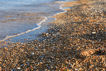 Obraz premium Pebbles mixed with sand of the beautiful Skala beach, Kefalonia island, Ionian sea, Greece.