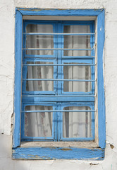 Fototapeta na wymiar old blue window on a wall