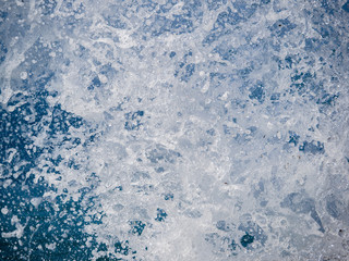 Splashes of water against the sea on a sunny summer day