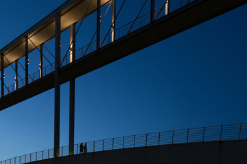 A couple is walking on a bridge in Berlin's government district