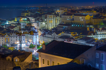 Naklejka premium A beautiful night long exposure aerial cityscape. View of historic central quarters, Rossio Square, Convento do Carmo, elevador de Santa Justa in evening illumination, Lisbon, Portugal.