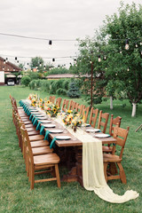 Table settings for a luxury wedding reception. Outdoor wedding