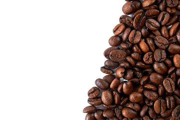 Coffee grains scattered on a white background with a place for an inscription.