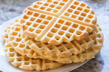 a stack of plain round waffles