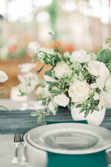 Table settings for a luxury wedding reception. Outdoor wedding