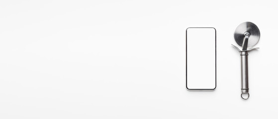 Phone with blank screen and pizza cutter