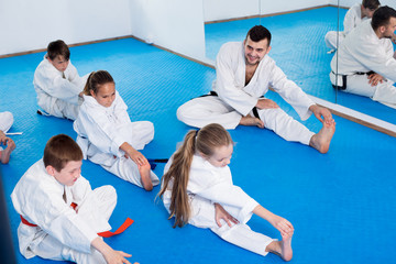 Fototapeta na wymiar Children getting ready and stretching for karate