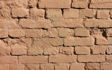 Brick wall old painted texture background of rough light orange stone structure. Grunge abstract bricks pattern on dirty masonry style 