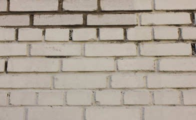 Brick wall texture background of grungy aged white brickwork pattern. Stone material surface close up view of rustic weathered textured brickwall 